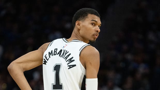 San Antonio Spurs center Victor Wembanyama looks back at a teammate during a game.